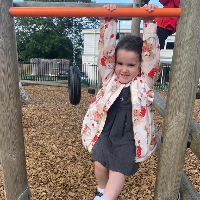 A hew kids playing outdoor in a park and having fun