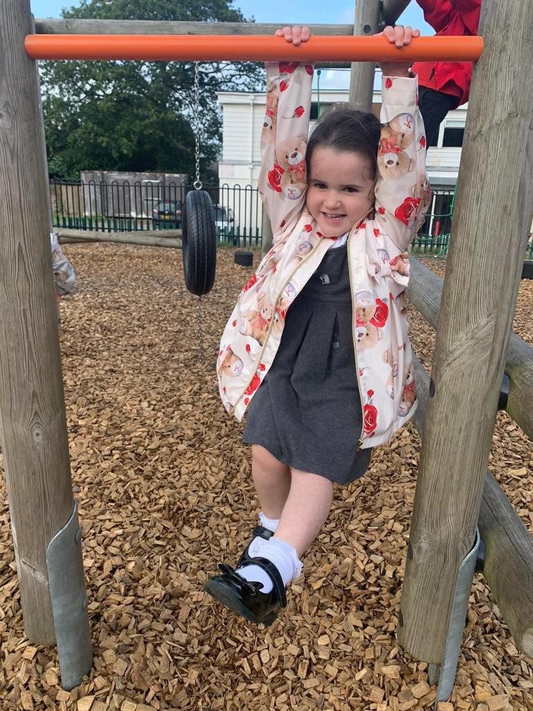 A hew kids playing outdoor in a park and having fun